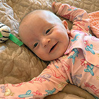 happy baby lying on a blanket